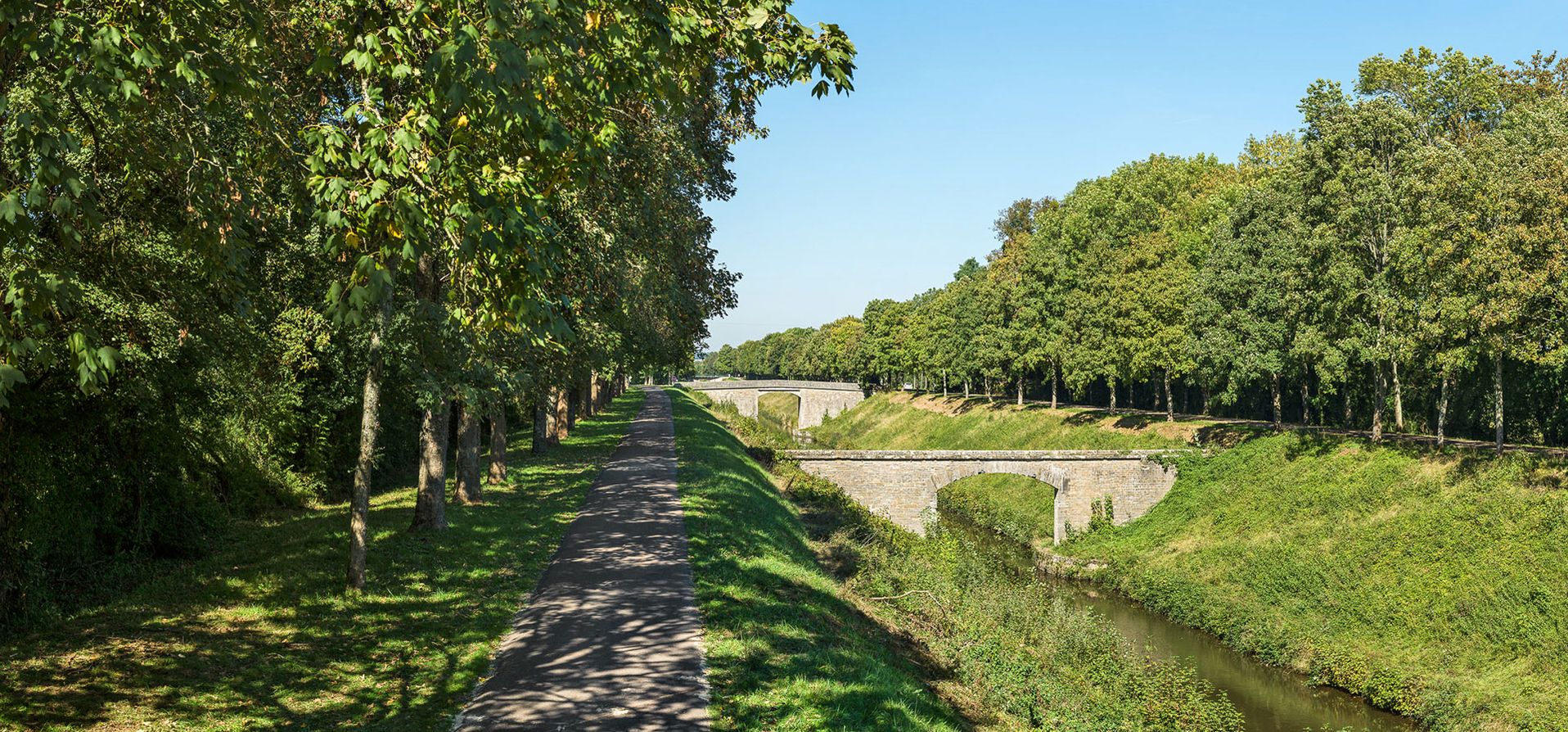 Au premier plan, la tranchée de La Chaise avec le pont-aqueduc de Varennes, suivi d’un pont routier isolé. Bief 25 du versant Seine à Pazy.