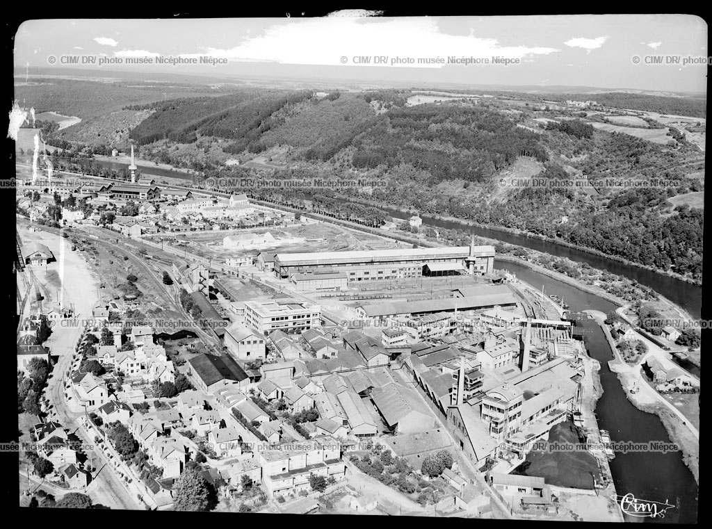 Clamecy (Nièvre) – Vue aérienne sur les usines – Le port Saint-Roch – L’Yonne – Le Canal du Nivernais et le Mont Sembert. Vers 1950. Négatif au gélatino-bromure d’argent sur plastique. Coll. Combier - musée Nicéphore Niépce – Chalon sur Saône – inv. &nbsp;1975.19.58079.9
Vue générale des bâtiments de la Société anonyme des Produits chimiques de Clamecy (SPCC) aujourd’hui usine Solvay.